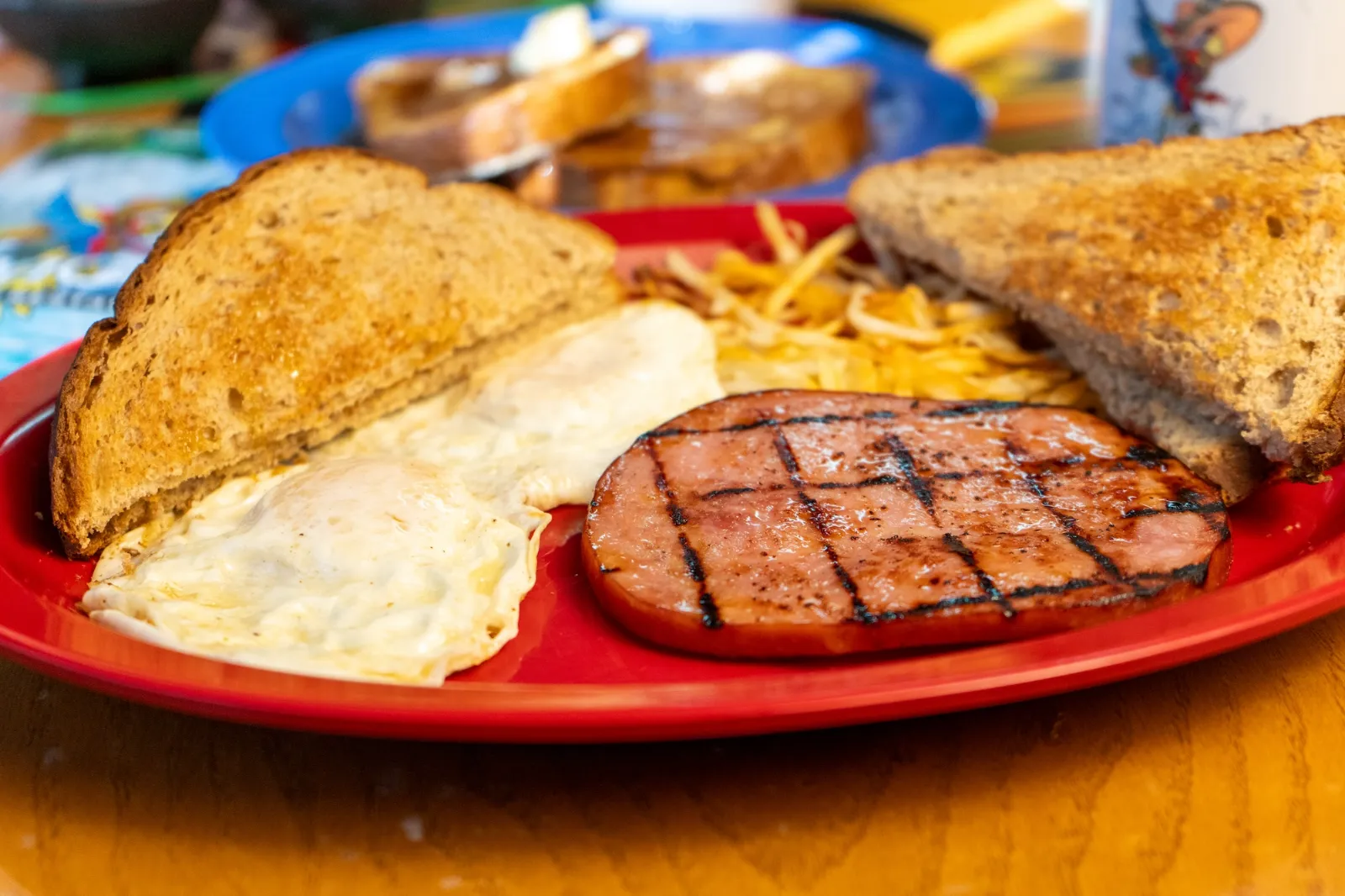 Grilled ham steak with eggs, hash browns and toast