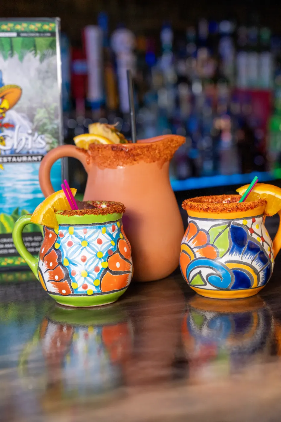 Michelada mugs and pitcher at the bar